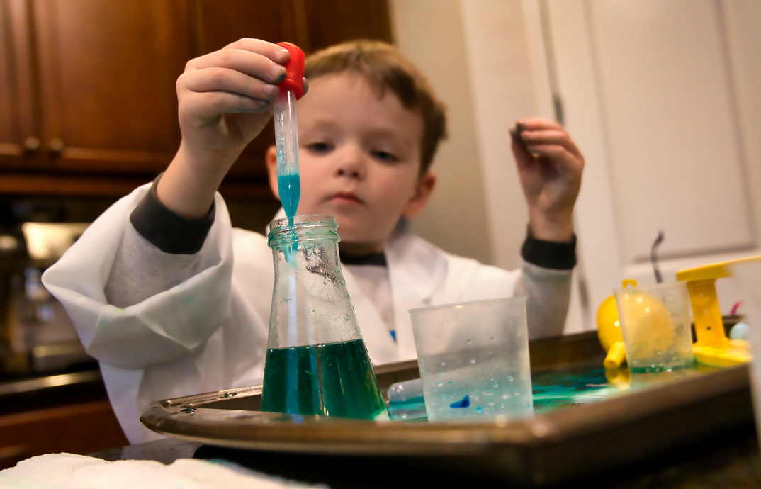child performing a science experiment